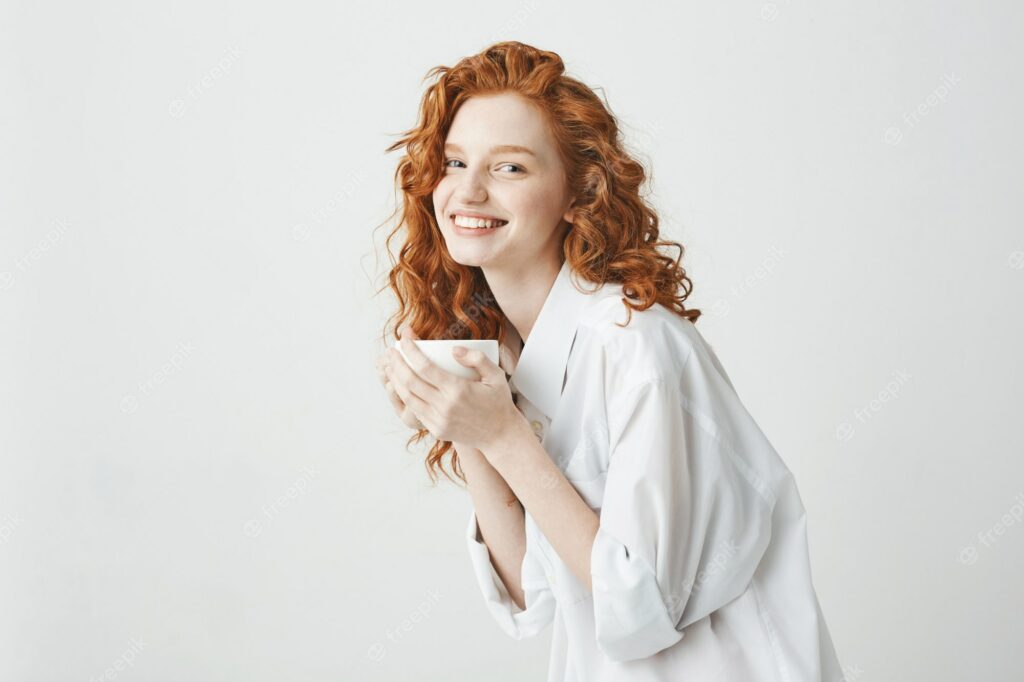 A woman holding a cup of coffee