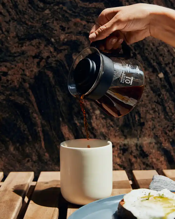 person pouring a coffee