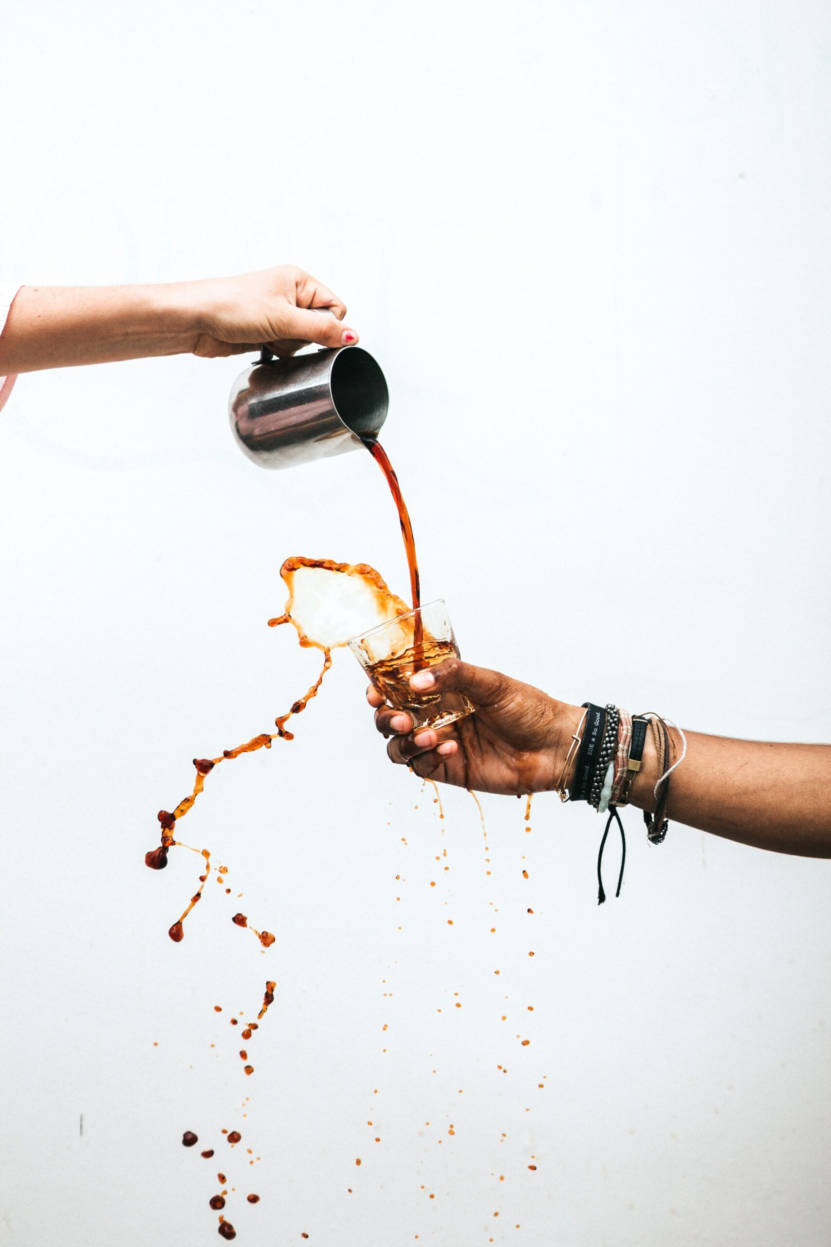 Person pouring coffee into cup